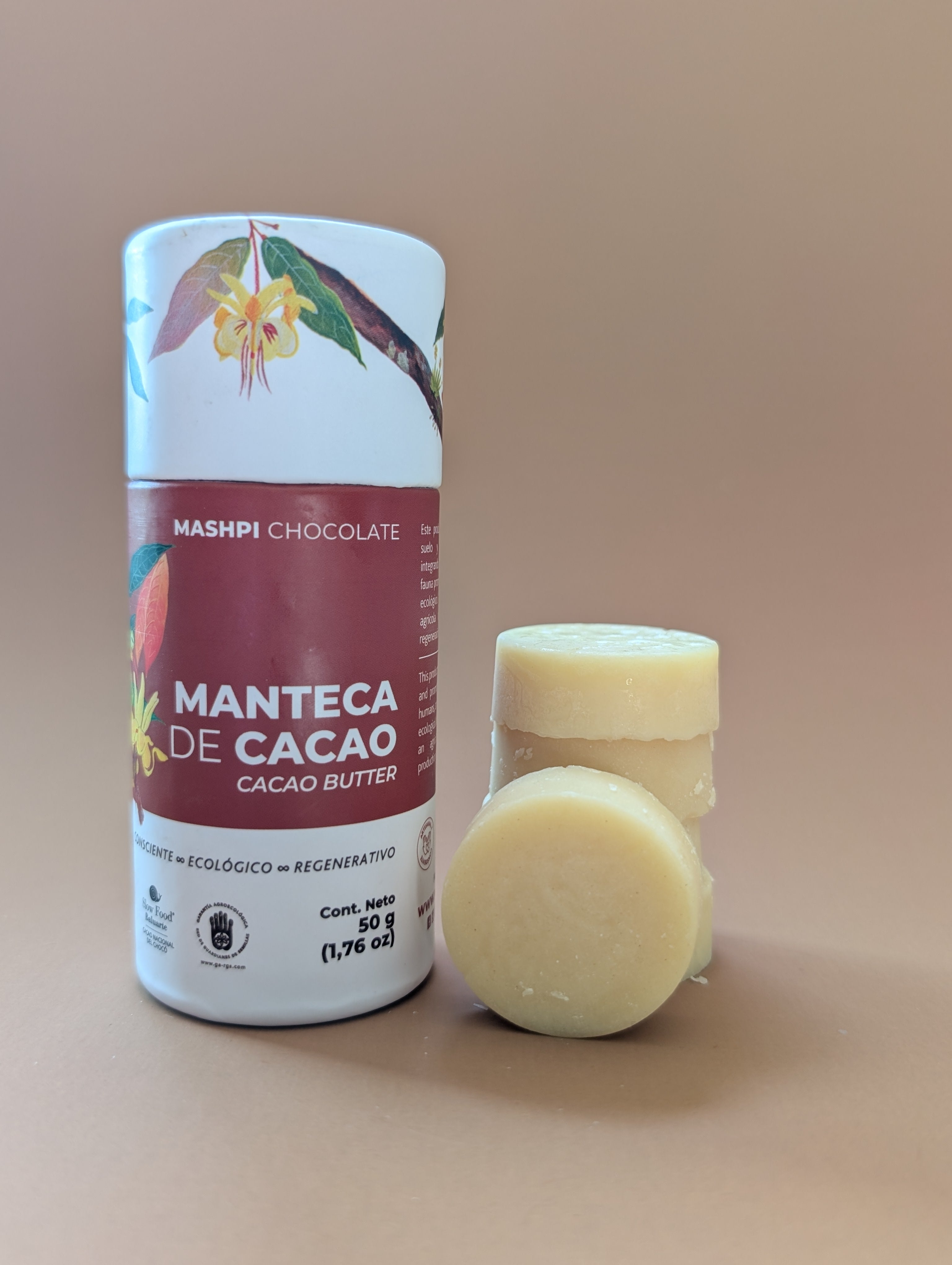Cacao butter container and solid bars on a beige background